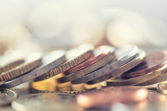 A pile of euro coins freely lying on the table. Close-up european money and currency