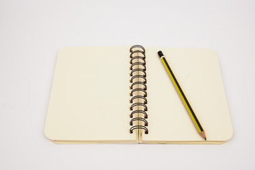 A pencil and a notebook isolated on a white background 