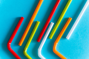 Colorful Plastic Cocktail Tubes Over Blue Background. Abstract Colorful Diagonal Lines.