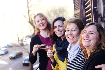 Women best friends smiling, drinking morning coffee