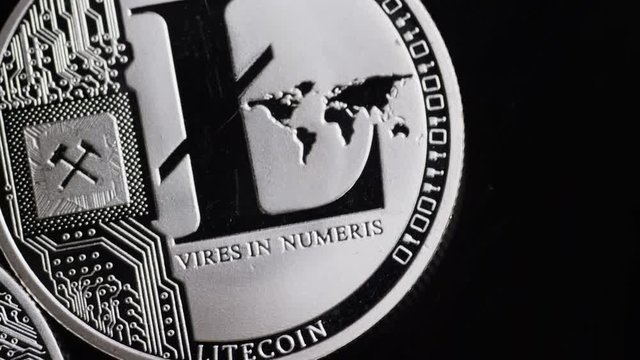Rotating shot of Bitcoins digital cryptocurrency - BITCOIN LITECOIN