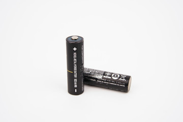 Black AA cell batteries on isolated white background