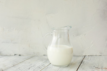 Glass jug and glass with milk