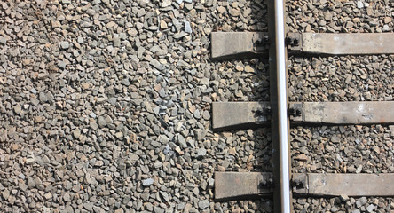 Fragment of the old railway track close-up. View from above. Background freight transport.