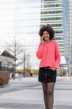 Black girl with the phone around the city