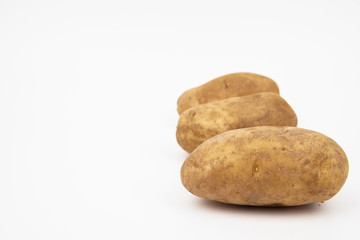 Fototapeta na wymiar Russet potato arrange in a row isolated on white background