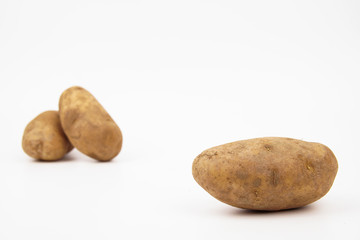 Fototapeta na wymiar Three raw russet potatoes isolated on white background