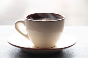 Cup of coffee on wooden background. Beverage coffee