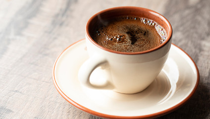 Cup of coffee on wooden background. Beverage coffee