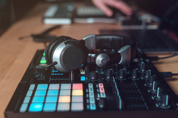 Fototapeta na wymiar DJ Adult man creates electronic music in the studio