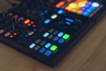 DJ tools for creating electronic music on a wooden table