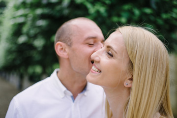 Fototapeta premium Head shot happy millennial young man and woman hugging embracing indoors. Portrait close up smiling husband and wife piggyback ride looking at camera laughing. Dating and romantic relationship concept