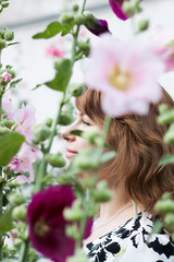 Naklejka premium beautiful girl surrounded by colorful flowers mallow