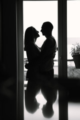 Couple with closed eyes. Woman and man near window. My love is true.