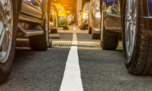 Asphalt Parking Lot Of The Airport Or Shopping Mall. Car Parking Area For Rent. Closeup Wheel Of Many Car Parked At Out Door Parking Lot. Automotive Industry. Car Parking Space. Global Used Car Market