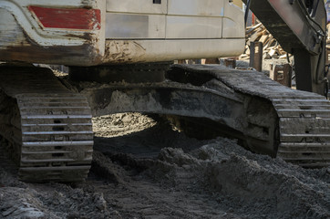 Tracked excavator at road construction