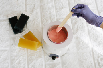 Fototapeta na wymiar preparing paste for sugaring or waxing in spa salon, close up