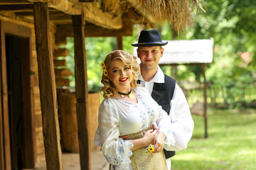 Fototapeta premium Beautiful couple posing outdoor in traditional clothes