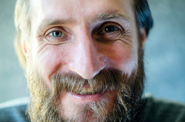 Close Up Portrait of A Man with a Beard is Talking and Laughing. Joyful Communication Concept. Mimic Wrinkles Around the Eyes.