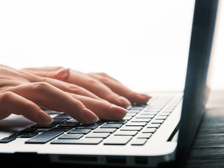 woman hand typing on keyboard
