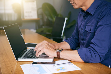 Businessman working at office with laptop