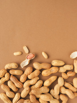 Organic peanuts on a brown background