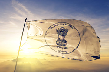 Meghalaya state of India flag waving on the top sunrise mist fog