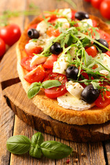 italian bruschetta with tomato, mozzarella, olive and basil