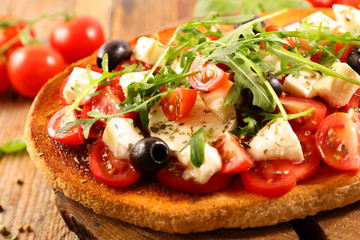 italian bruschetta with tomato, mozzarella, olive and basil