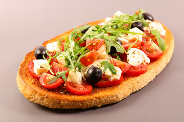 italian bruschetta with tomato, mozzarella, olive and basil