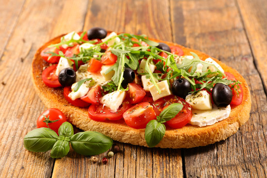 italian bruschetta with tomato, mozzarella, olive and basil