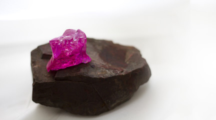 close up background of brown jasper stone and transparent purple crystal on white blurred background