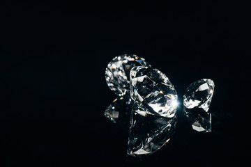 transparent pure diamonds isolated on black with reflection - obrazy, fototapety, plakaty