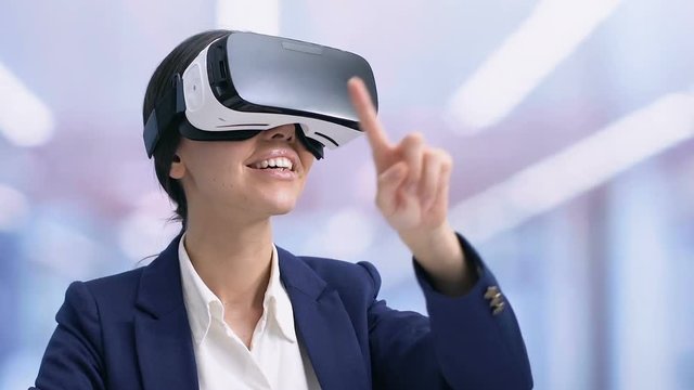 Smiling businesslady in VR headset preparing presentation, modern technologies