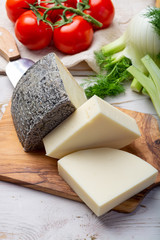 Italian cheeses, mature Tuscan Pecorino sheep cheese and Provolone dolce cow cheese served with olive bread and tomatoes