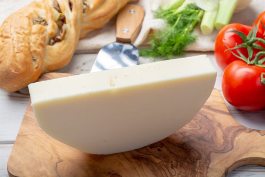 Italian cheese, Provolone dolce cow cheese from Cremona served with olive bread and tomatoes