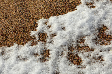Snow on sea sand