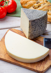 Italian cheeses, mature Tuscan Pecorino sheep cheese and Provolone dolce cow cheese served with olive bread and tomatoes