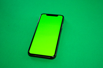 iPhone XS, Phone smartphone, green screen on Green background, top view