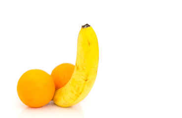 One banana and two orange fruts isolated on white background. Concept - male potency.