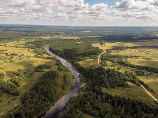 View of the forest river in the summer with a drone