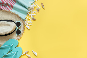 Outfit for beach and tropical vacations, straw sunhat, sun glasses on yellow. Summer.