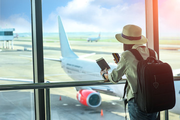 woman passenger or traveler tourist looking at next flight schedule on mobile, in worry of the...