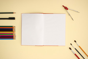 School and art supplies on yellow background © Long Frame