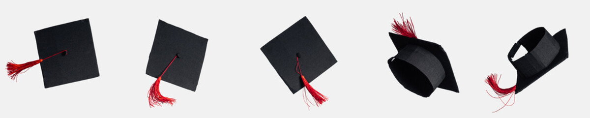 Panoramic shot of academic caps with red tassels isolated on white