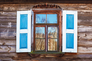 Naklejka na ściany i meble Wooden rustic window in small cottage house. Vintage wall with transparent glass window and decorative blue and white shutter.