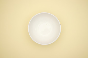 Pasta in white dish on yellow background