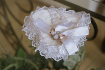 Wedding rings on white pillow like hurt. wedding concept