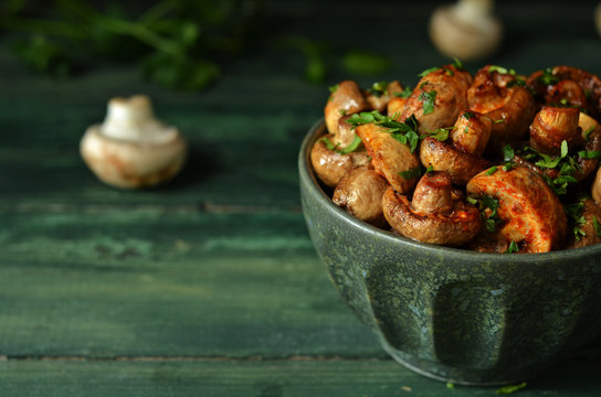 Fried Mushrooms With Parsley And Balsamic Vinegar In A Green Bowl