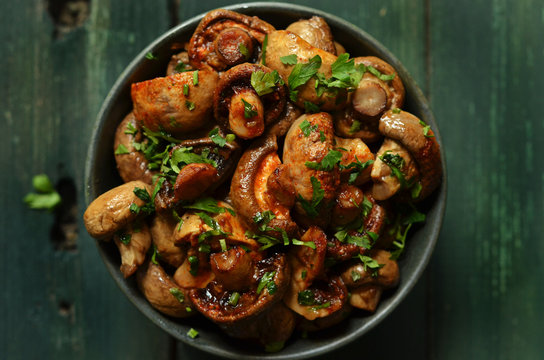 Baked Mushrooms With Balsamic Vinegar In A Rustic Bowl